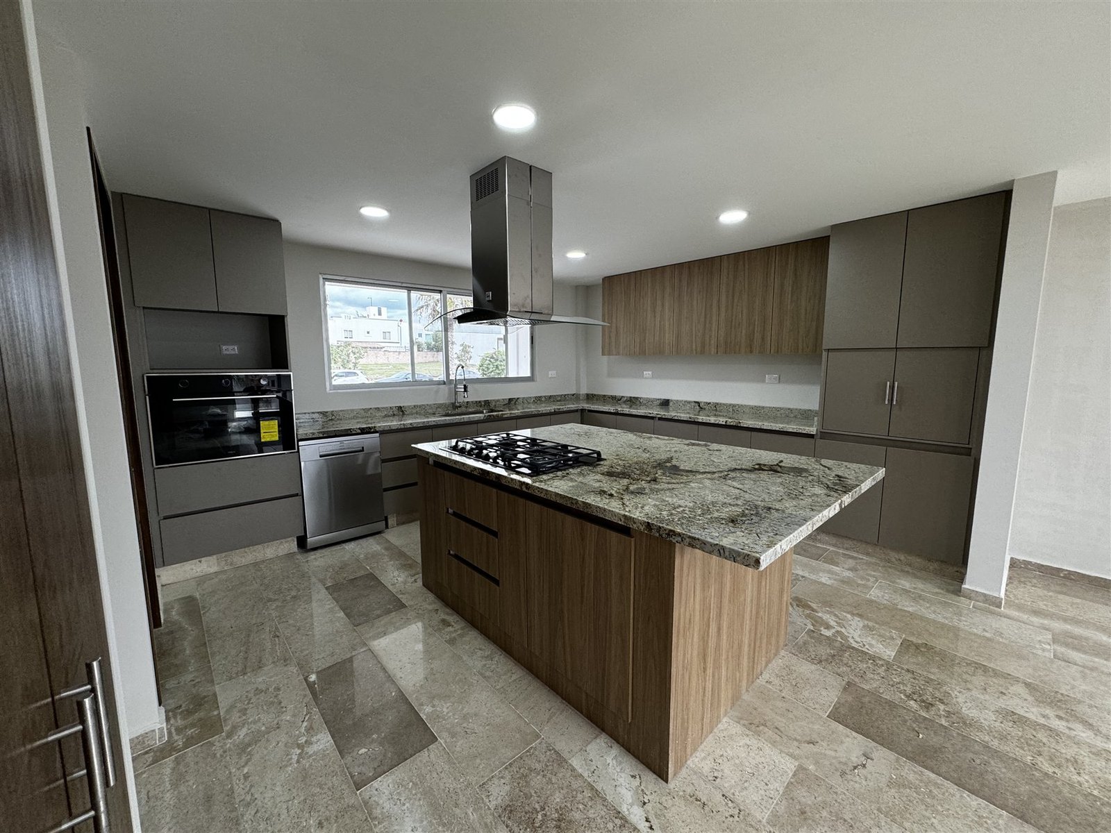 Cocina integral con isla y piso de piedra