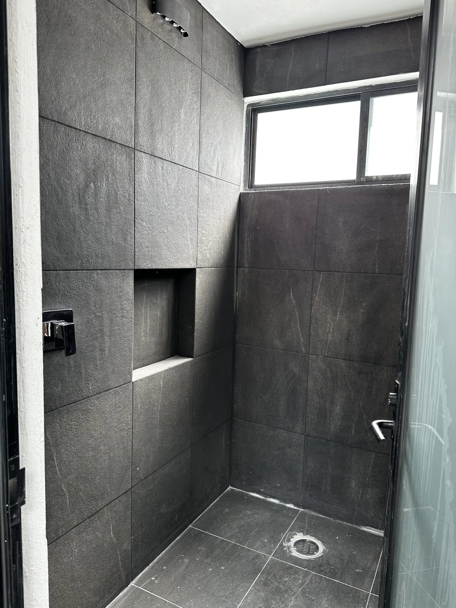 Regadera con porcelanato oscuro